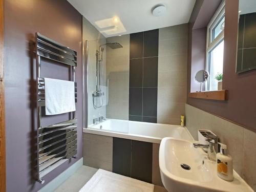 a bathroom with a sink and a tub and a mirror at 3 Bed in North Shields oc-b29939 in Tynemouth