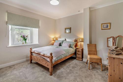 a bedroom with a bed and a window and a chair at 4 Bed in Kinniside oc-c28854 in Frizington