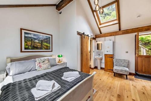 a bedroom with a large bed and a bathroom at 3 Bed in Fucheswen oc-m29608 in Blaenau-Ffestiniog
