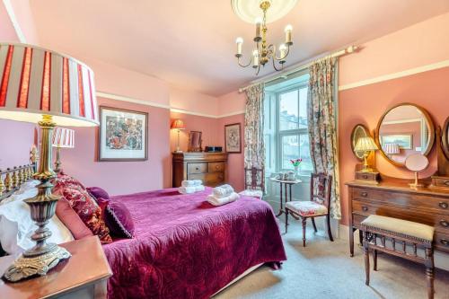 a bedroom with a bed and a dresser and a mirror at 4 Bed in Alnmouth oc-a30221 in Alnmouth