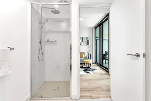 a bathroom with a shower with a glass door at Level 18 Heart of Adelaide with Gym, City Views in Adelaide