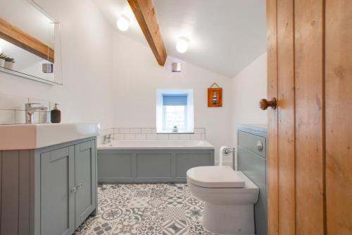 a bathroom with a toilet and a sink and a tub at 3 Bed in Askrigg oc-ds1049 in Askrigg