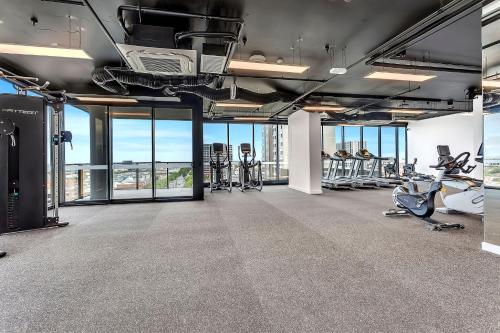 a gym with treadmills and exercise equipment in a building at Level 18 Heart of Adelaide with Gym, City Views in Adelaide