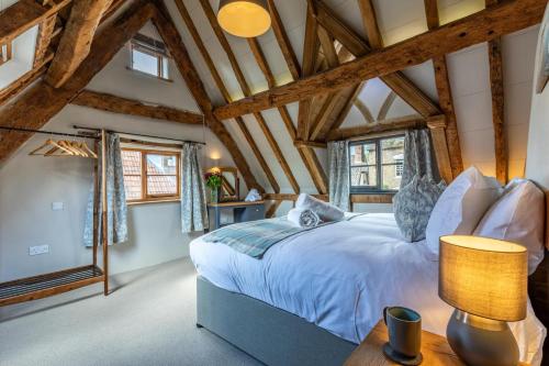 a bedroom with a large bed and wooden ceilings at 5 Bed in Frampton On Severn oc-d29489 in Frampton on Severn