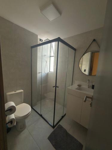 a bathroom with a shower and a toilet and a sink at Lindo Studio com rooftop e piscina in Cabedelo