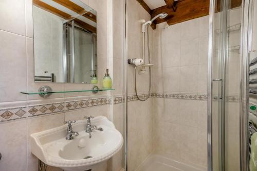 a bathroom with a sink and a shower at 4 Bed in Heywood oc-t29040 in Westbury