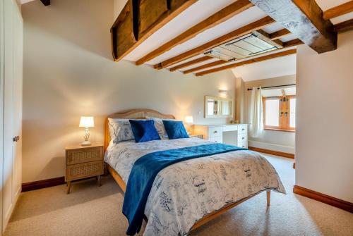a bedroom with a bed with blue sheets and a window at 4 Bed in Heywood oc-t29040 in Westbury