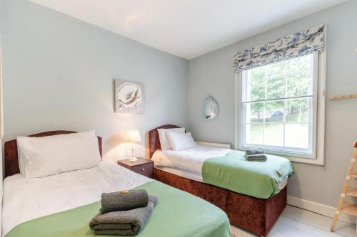 a bedroom with two beds and a window at 4 Bed in Matlock Bath oc-r32432 in Matlock Bank