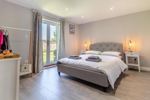 a bedroom with a large bed and a large window at 2 Bed in Oxborough oc-r29291 in Oxborough