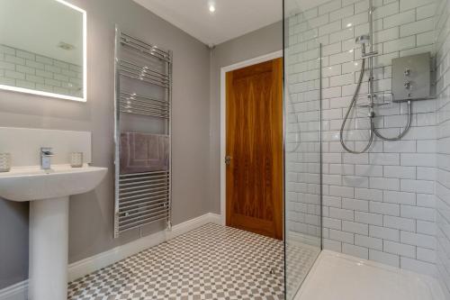 a bathroom with a shower and a sink and a mirror at 2 Bed in Oxborough oc-r29291 in Oxborough