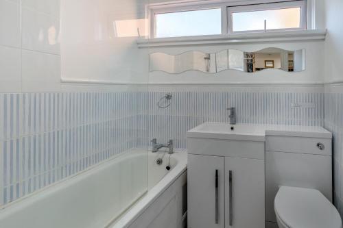 a bathroom with a tub and a toilet and a sink at 2 Bed in Langland oc-f30206 in Newton