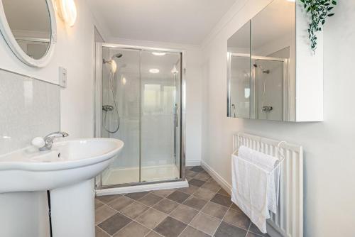 a white bathroom with a sink and a shower at 3 Bed in Longtown oc-h30069 in Longtown