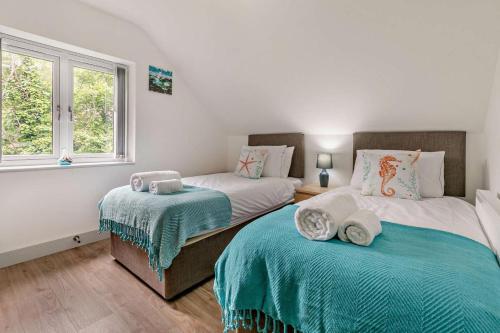 a bedroom with two beds and a window at 4 Bed in Retorrick Mill oc-w28897 in Saint Mawgan