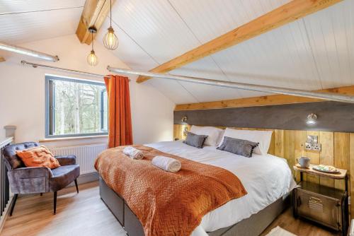 a bedroom with a large bed and a chair at 1 Bed in Berriew oc-a31113 in Berriew