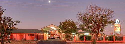 a building with a sign in front of a motel at Across Country Motor Inn in Dubbo