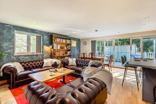 a living room with leather couches and a table at 2 Bed in West Quantoxhead oc-p30893 in West Quantoxhead