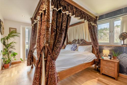 a bedroom with a canopy bed and a window at 2 Bed in West Quantoxhead oc-p30893 in West Quantoxhead