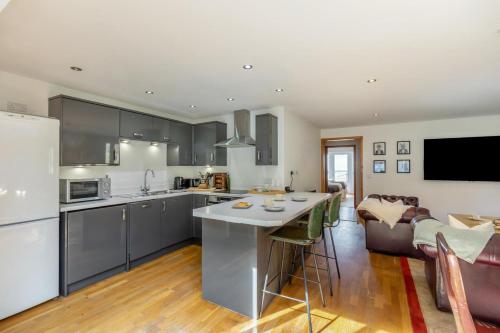 a kitchen and living room with a couch and a table at 2 Bed in West Quantoxhead oc-p30893 in West Quantoxhead