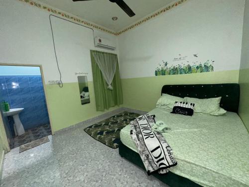 a bedroom with a bed and a sink and a mirror at Olive Cottage in Marang