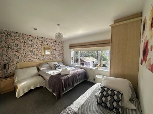 a bedroom with a bed and a window at Station Approach B&B Boutique Stays in Solihull