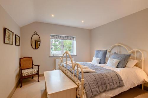 a bedroom with a bed and a chair and a window at 3 Bed in Syderstone oc-a27669 in Syderstone