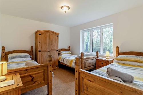 a bedroom with two beds and a window at 5 Bed in Pentney oc-w27337 in Pentney