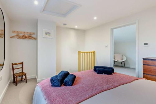 a bedroom with a bed with two blue pillows on it at 1 Bed in Syderstone oc-c29233 in Syderstone