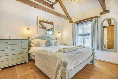 a bedroom with a bed with a dresser and a window at 3 Bed in Padstow oc-h28928 in Padstow