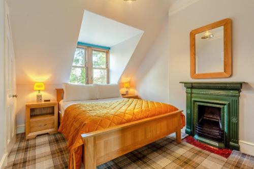 a bedroom with a bed and a fireplace at 3 Bed in Huntly oc-g31733 in Huntly