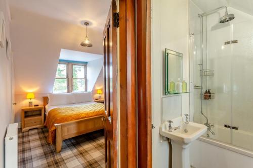 a bedroom with a bed and a sink and a shower at 3 Bed in Huntly oc-g31733 in Huntly