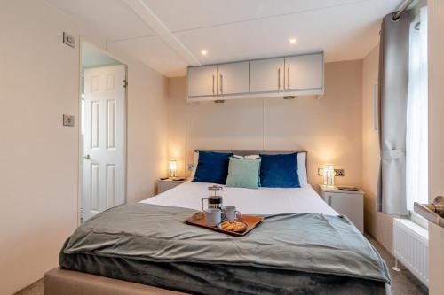 a bedroom with a bed with a tray of food on it at 2 Bed in Sewerby oc-s31941 in Sewerby
