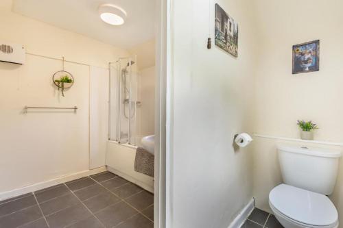 a bathroom with a toilet and a shower at 3 Bed in Stowupland oc-p32216 in Stowmarket