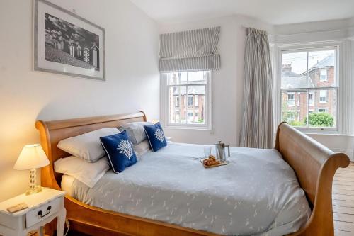 a bedroom with a bed with blue and white pillows at 3 Bed in Southwold oc-rvil in Southwold