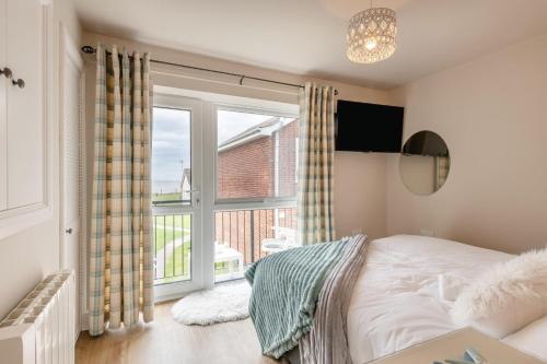 a bedroom with a bed and a large window at 3 Bed in Corton oc-s32347 in Corton