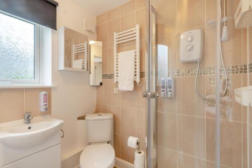a bathroom with a toilet and a sink and a shower at 3 Bed in Corton oc-s32347 in Corton