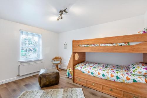 a bedroom with a bunk bed and a chair at 5 Bed in St. Bees oc-w32446 in St Bees