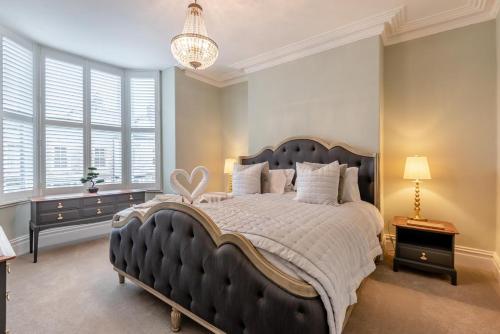 a large bedroom with a large bed and a chandelier at 6 Bed in Buxton oc-s31063 in Buxton
