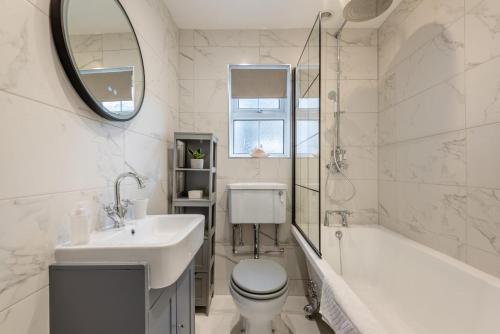a white bathroom with a sink and a toilet and a tub at 6 Bed in Buxton oc-s31063 in Buxton