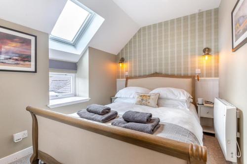 a bedroom with a bed with towels on it at 2 Bed in Newtonmore oc-e32418 in Newtonmore