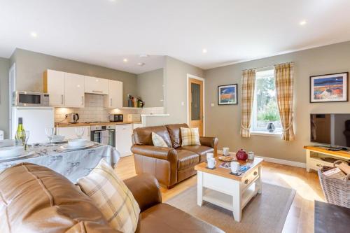a living room with a couch and a table at 2 Bed in Newtonmore oc-e32418 in Newtonmore
