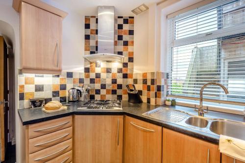 a kitchen with a sink and a stove top oven at 3 Bed in Lytham St. Annes oc-m30622 in Saint Annes on the Sea