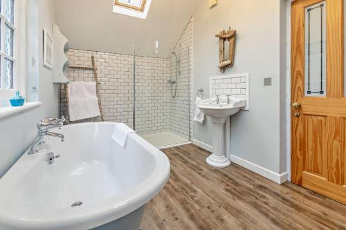 a bathroom with a white tub and a sink at 3 Bed in Sennen Cove oc-c29670 in Sennen