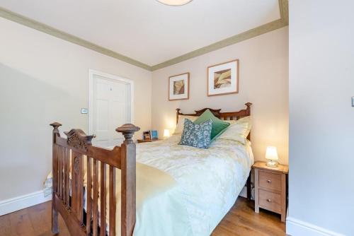 a bedroom with a large bed with a wooden headboard at 1 Bed in Brynteg oc-g32079 in Llanwenog