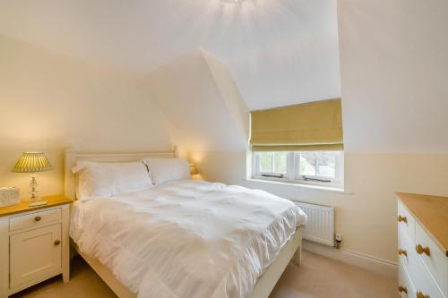 a bedroom with a white bed and a window at 3 Bed in West Lulworth oc-s32114 in West Lulworth