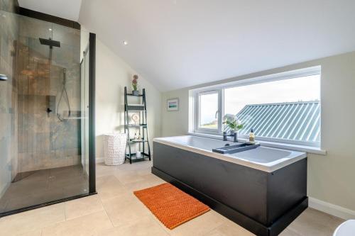 a bathroom with a large tub and a window at 1 Bed in Llanover oc-y30114 in Llanover