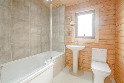 a bathroom with a toilet and a sink and a shower at 3 Bed in Llanddulas oc-r27872 in Llanddulas
