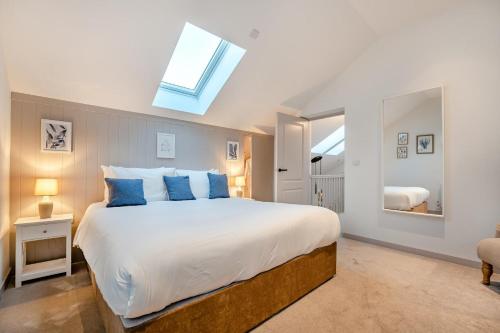 a bedroom with a large bed with blue pillows at 2 Bed in Lancing oc-t29902 in Lancing