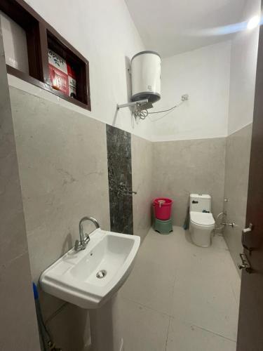 a bathroom with a sink and a toilet at Royal living hotal in Bathinda