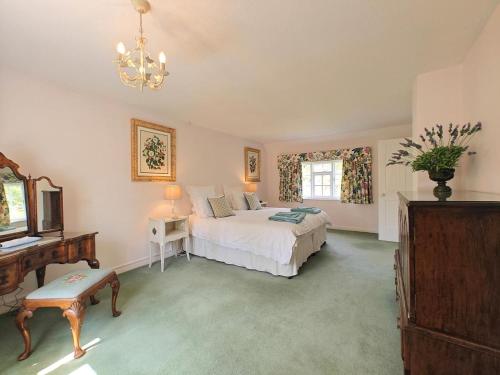 a bedroom with a bed and a table and a window at 2 Bed in Chilmark oc-w32753 in Chilmark