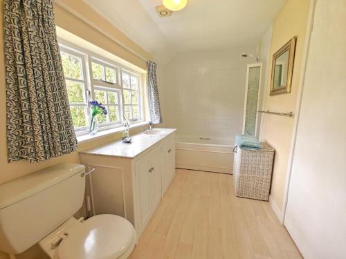 a bathroom with a toilet and a sink and a window at 2 Bed in Chilmark oc-w32753 in Chilmark